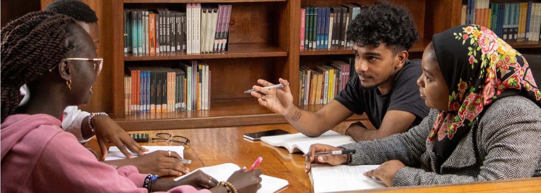 Students working together at a reading table in Riara University Library